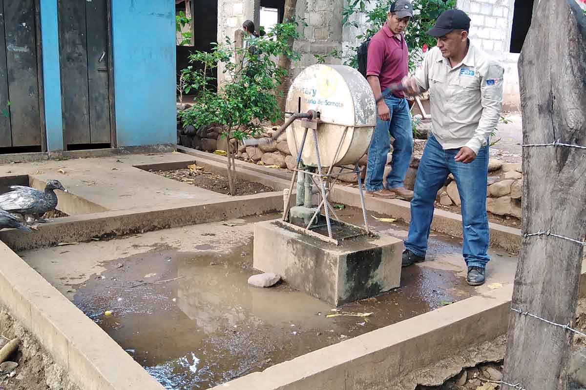 Project technicians review condition of community wells and water storage infrastructure 1.jpg